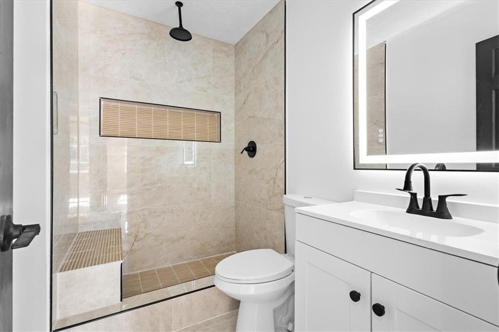 7605 Raleigh Lane Jonesboro, GA 30236 - Photo 32 of 40 a bathroom with a sink toilet and shower