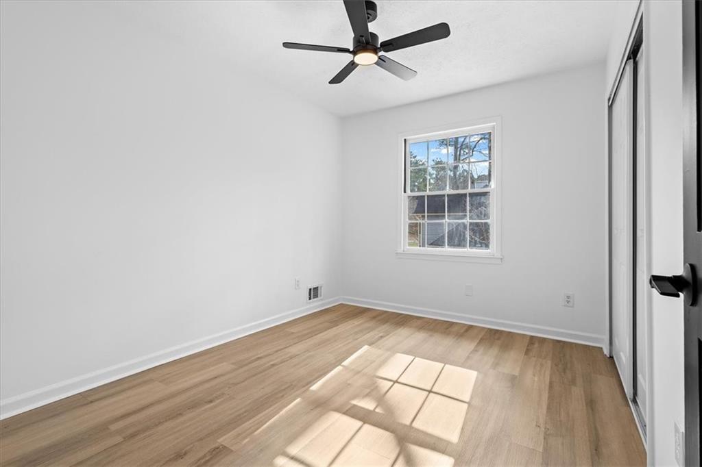 7605 Raleigh Lane Jonesboro, GA 30236 - Photo 33 of 40 wooden floor in an empty room with a window