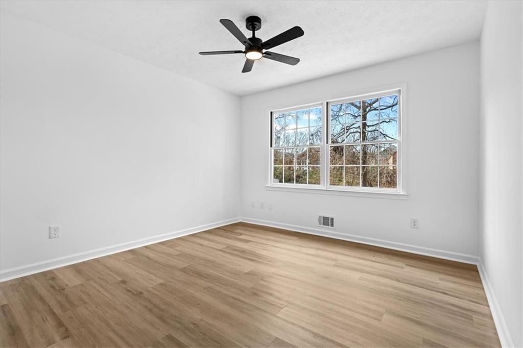 7605 Raleigh Lane Jonesboro, GA 30236 - Photo 35 of 40 an empty room with wooden floor and windows