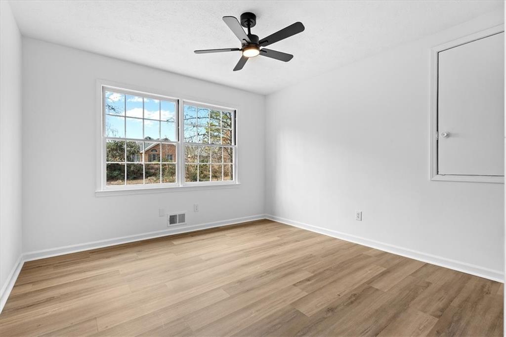 7605 Raleigh Lane Jonesboro, GA 30236 - Photo 37 of 40 a view of empty room with wooden floor and fan
