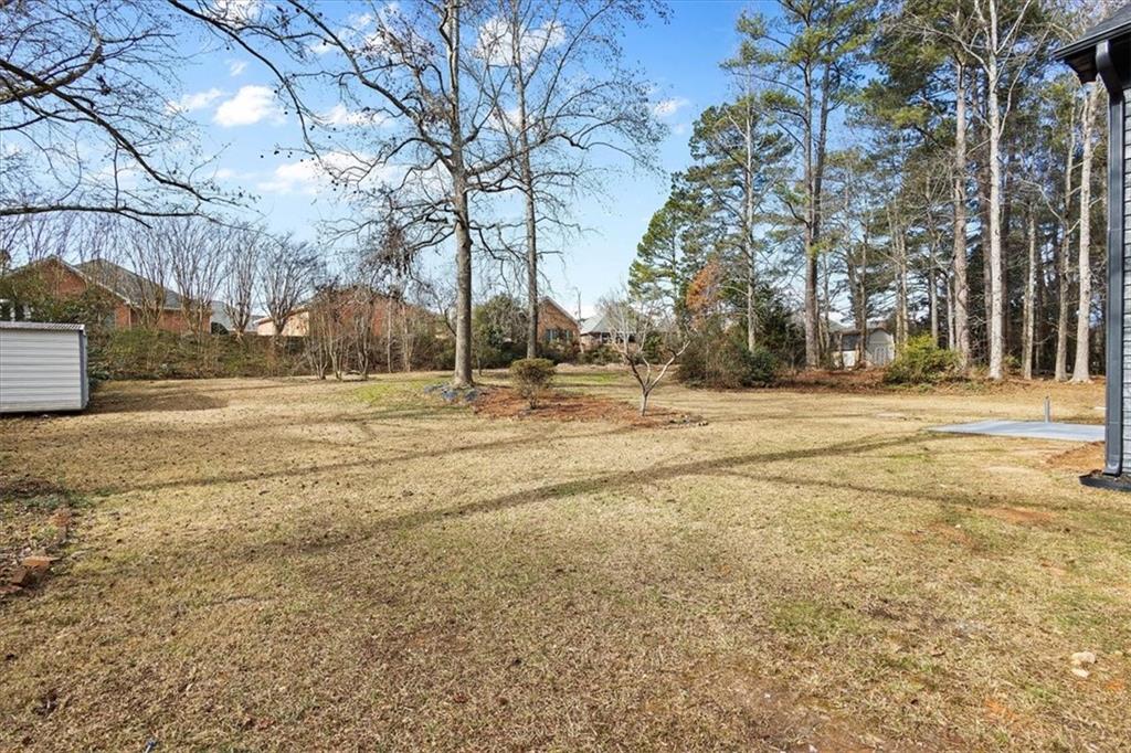 7605 Raleigh Lane Jonesboro, GA 30236 - Photo 6 of 40 a backyard of apartments with large trees