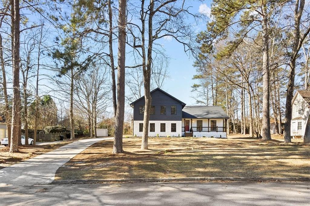 7605 Raleigh Lane Jonesboro, GA 30236 - Photo 9 of 40 a front view of a building with a cars parked