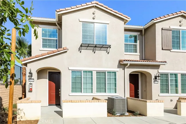 a front view of a house with large windows