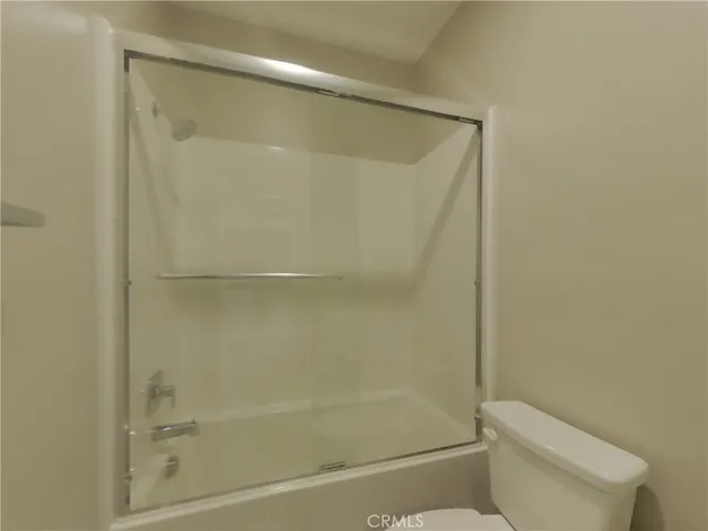 a bathroom with a shower and a toilet