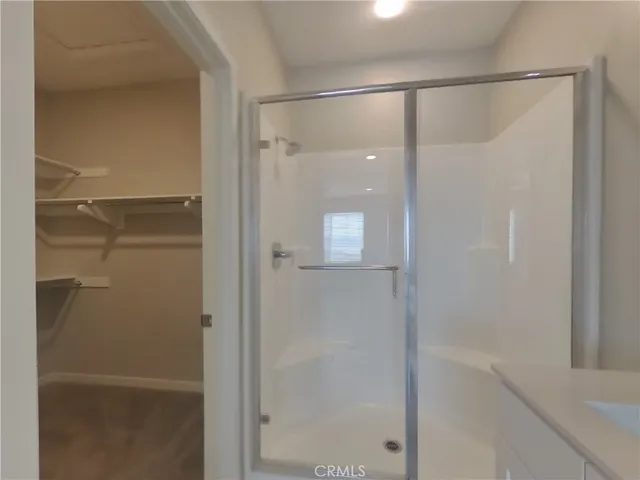 a bathroom with a glass shower door