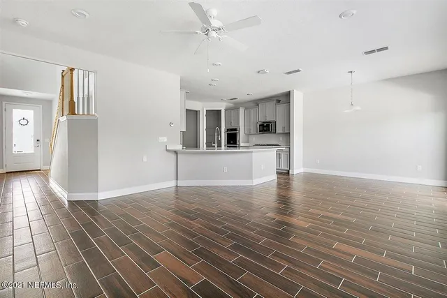 a view of a kitchen with a sink and a microwave