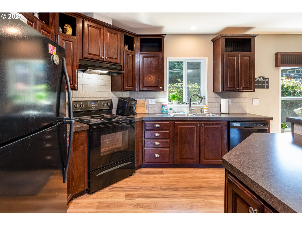 466 South 71st Street Springfield, OR 97478 - Photo 11 of 33 a kitchen with stainless steel appliances granite countertop a stove a sink and a microwave
