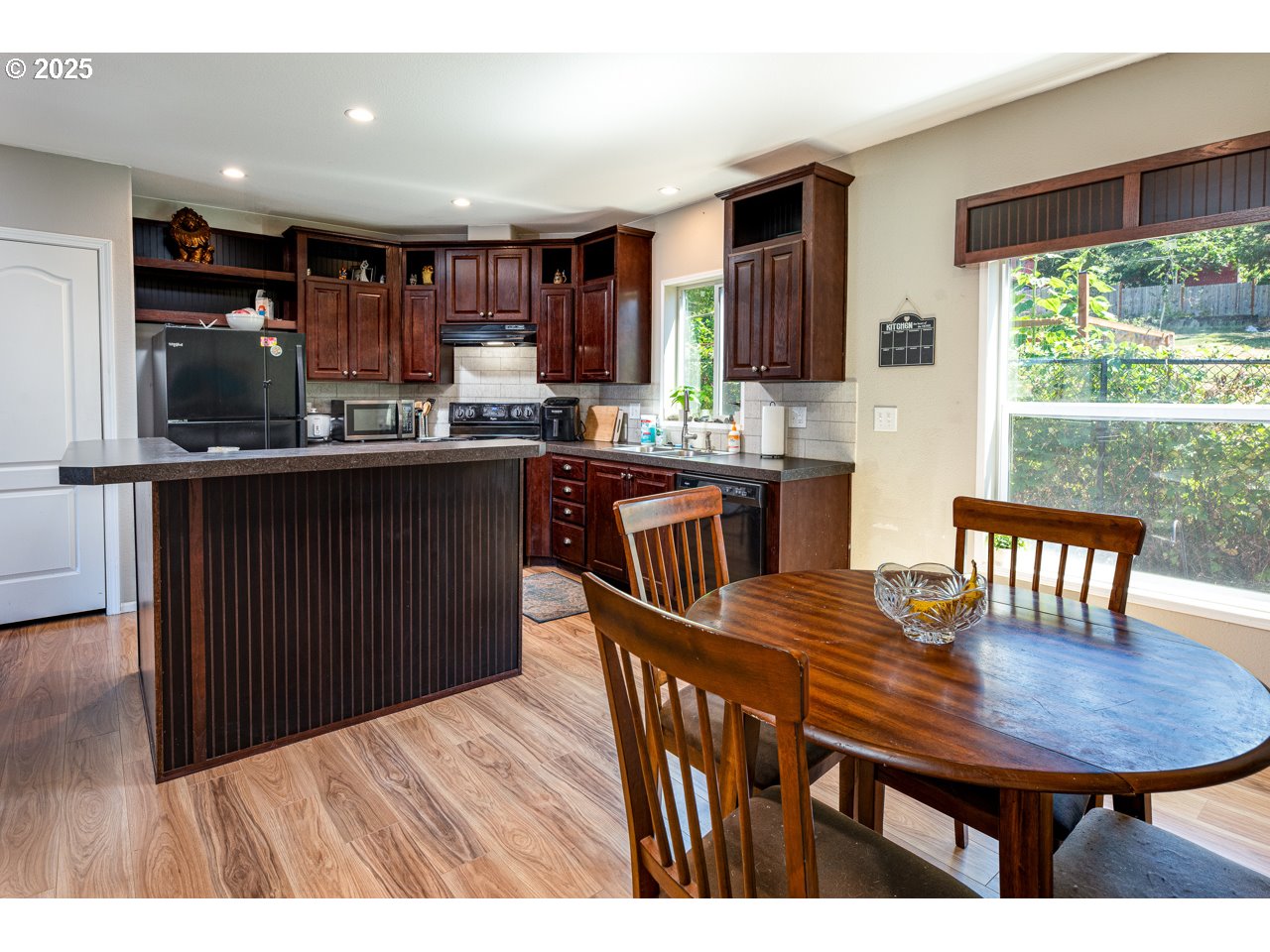 466 South 71st Street Springfield, OR 97478 - Photo 7 of 33 a kitchen with stainless steel appliances granite countertop a sink a stove a dining table and chairs