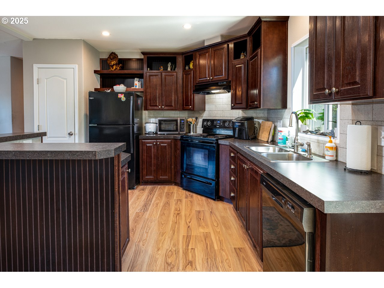 466 South 71st Street Springfield, OR 97478 - Photo 8 of 33 a kitchen with stainless steel appliances granite countertop a refrigerator a sink dishwasher a stove with wooden cabinets