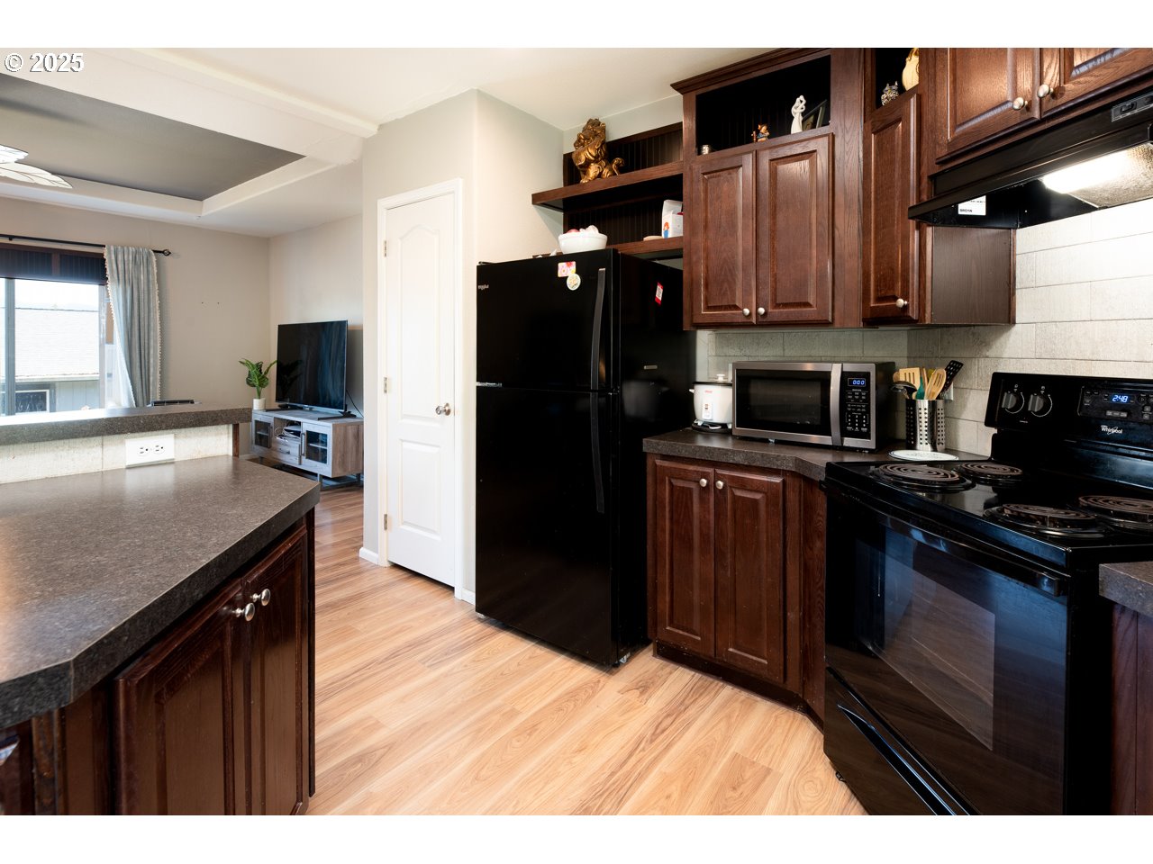 466 South 71st Street Springfield, OR 97478 - Photo 9 of 33 a kitchen with granite countertop stainless steel appliances and wooden cabinets