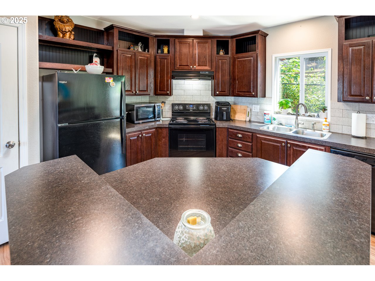 466 South 71st Street Springfield, OR 97478 - Photo 10 of 33 a kitchen with stainless steel appliances granite countertop a refrigerator a stove a sink dishwasher and wooden cabinets with wooden floor