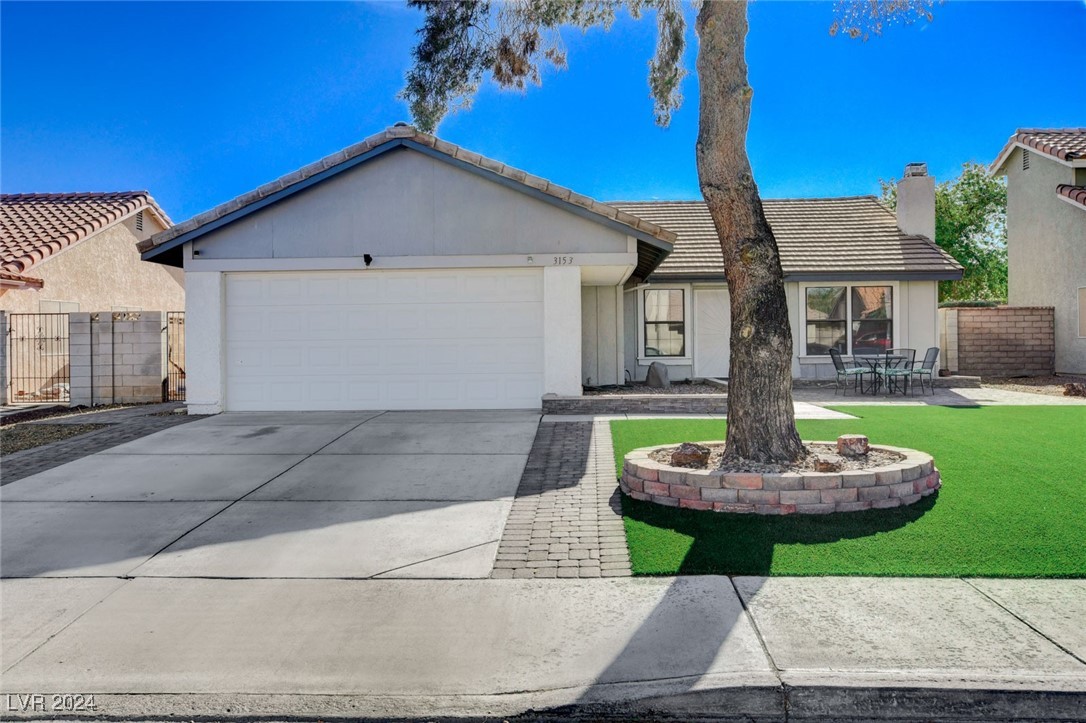 Eye-catching curb appeal as you note the nicely manicured green turf lawn and adorable brick pavered patio.