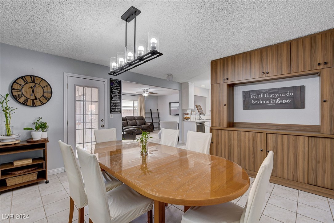 3153 Viewcrest Avenue Henderson, NV 89014 - Photo 18 of 49 Dining area off the Kitchen includes a built-in Hutch and can be used as everyday dining or a Formal Dining Room. Features a door to the backyard patio with built-in BBQ for convenience. NOte the beautiful lighting fixture.