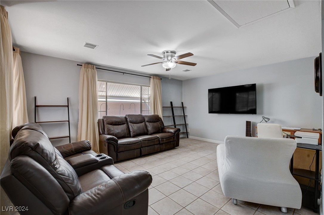 3153 Viewcrest Avenue Henderson, NV 89014 - Photo 19 of 49 Off the Kitchen and Dining Area is a large Family Room overlooking the rear yard with a continuation of easy-care tile flooring.