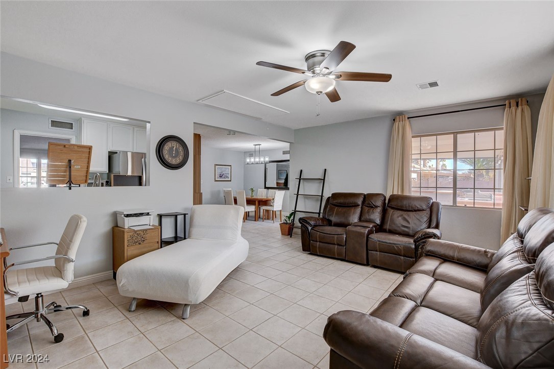 3153 Viewcrest Avenue Henderson, NV 89014 - Photo 21 of 49 Off the Kitchen and Dining Area is a large Family Room overlooking the rear yard with a continuation of easy-care tile flooring.