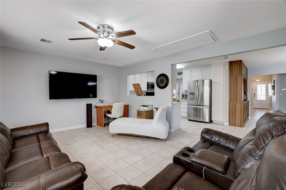 3153 Viewcrest Avenue Henderson, NV 89014 - Photo 22 of 49 Off the Kitchen and Dining Area is a large Family Room overlooking the rear yard with a continuation of easy-care tile flooring.