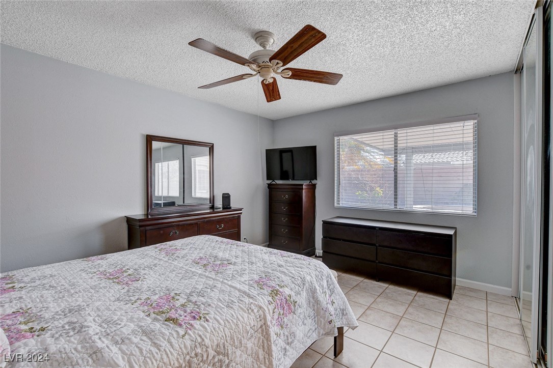 3153 Viewcrest Avenue Henderson, NV 89014 - Photo 23 of 49 Master Bedroom features ceiling fan and triple closet with mirrored doors.