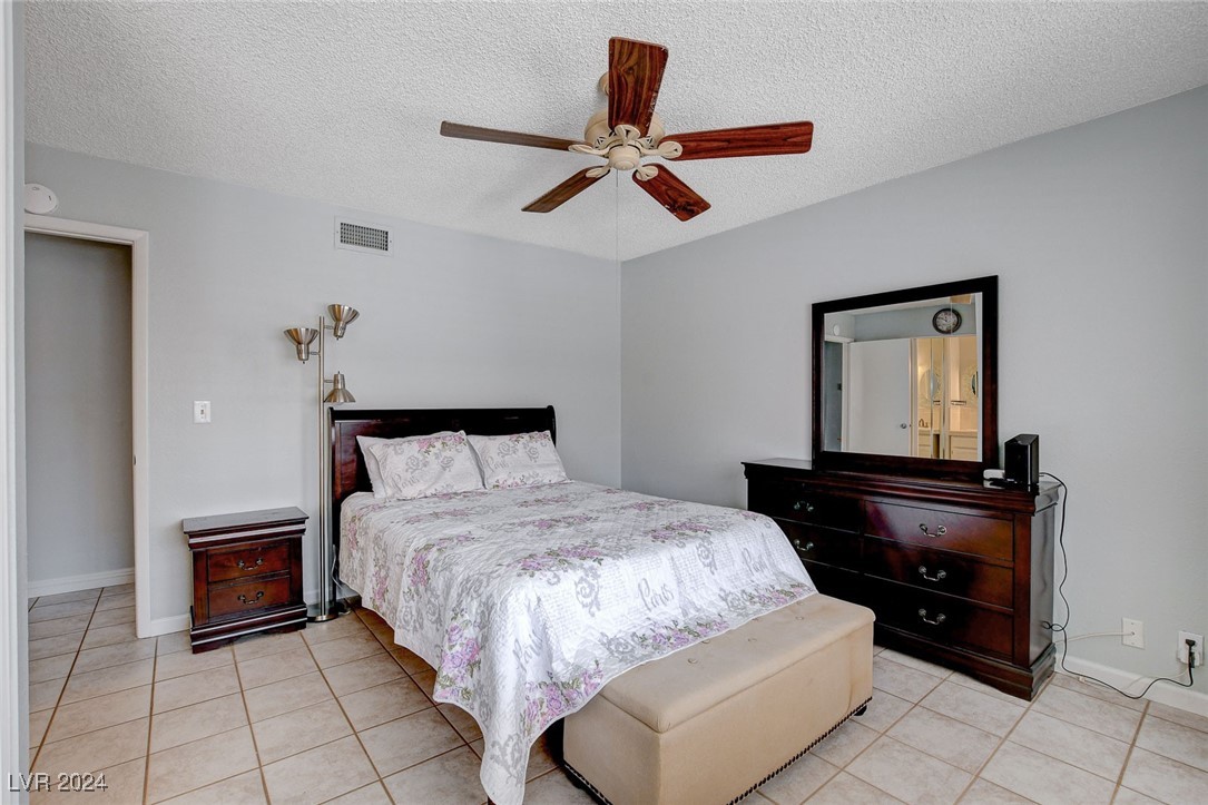 3153 Viewcrest Avenue Henderson, NV 89014 - Photo 24 of 49 Master Bedroom features ceiling fan and triple closet with mirrored doors.