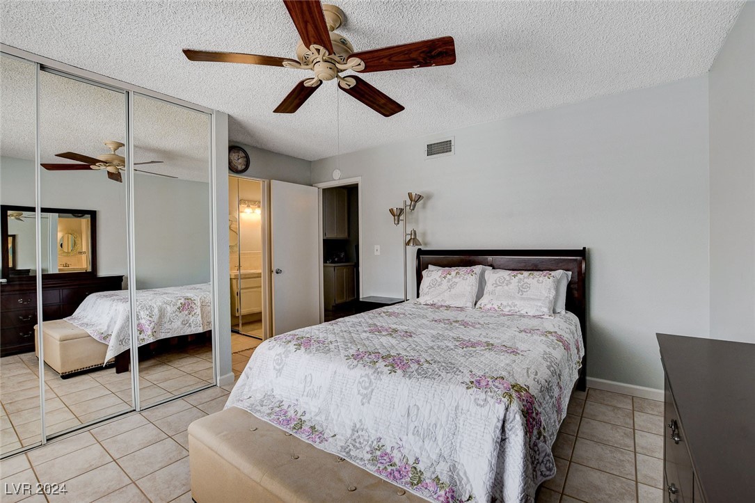 3153 Viewcrest Avenue Henderson, NV 89014 - Photo 25 of 49 Master Bedroom features ceiling fan and triple closet with mirrored doors.