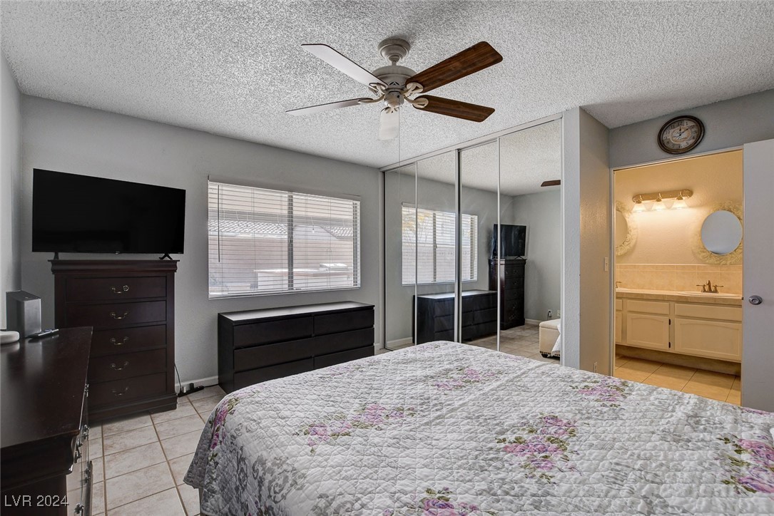 3153 Viewcrest Avenue Henderson, NV 89014 - Photo 26 of 49 Master Bedroom features ceiling fan and triple closet with mirrored doors.