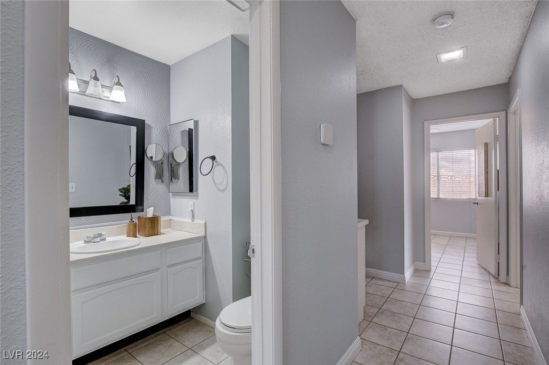 3153 Viewcrest Avenue Henderson, NV 89014 - Photo 30 of 49 Hall Bath features modern white cabinet with cultured marble vanity top and tub/shower combo.