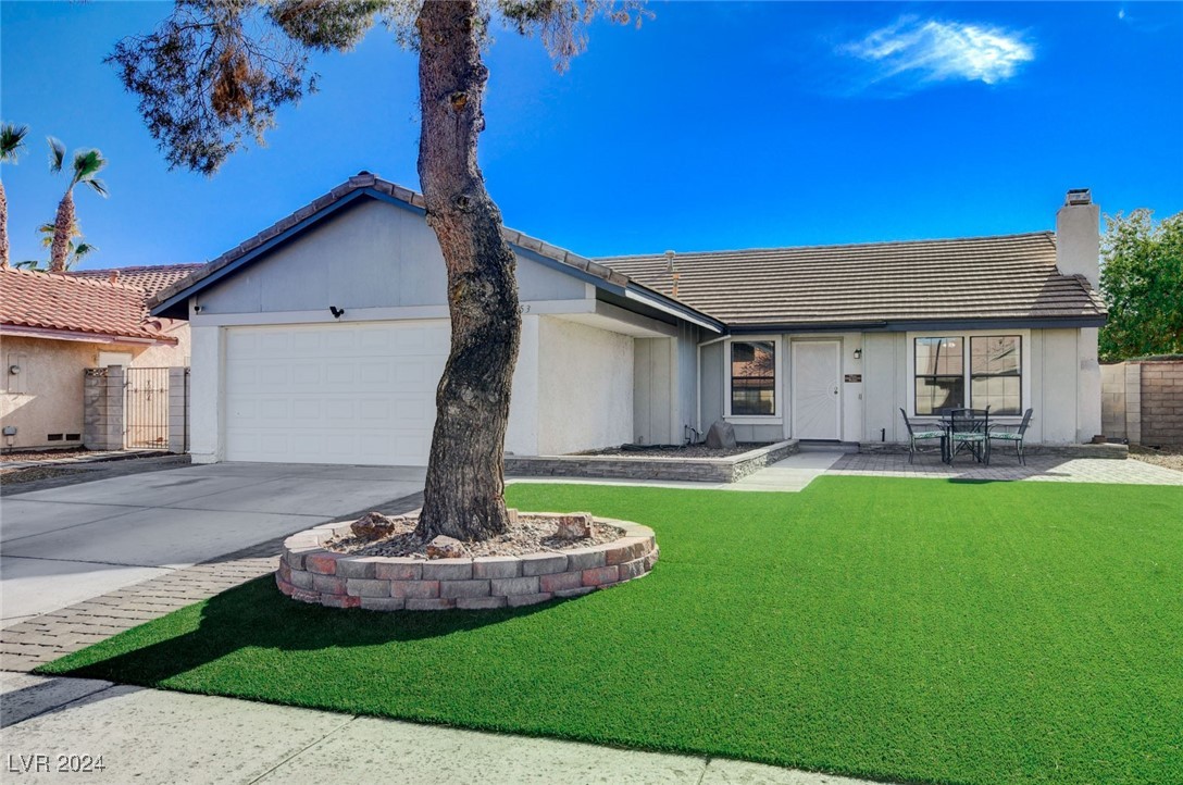3153 Viewcrest Avenue Henderson, NV 89014 - Photo 3 of 49 Eye-catching curb appeal as you note the nicely manicured green turf lawn and adorable brick pavered patio.