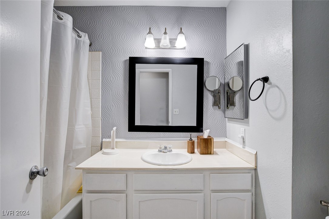 3153 Viewcrest Avenue Henderson, NV 89014 - Photo 31 of 49 Hall Bath features modern white cabinet with cultured marble vanity top and tub/shower combo.