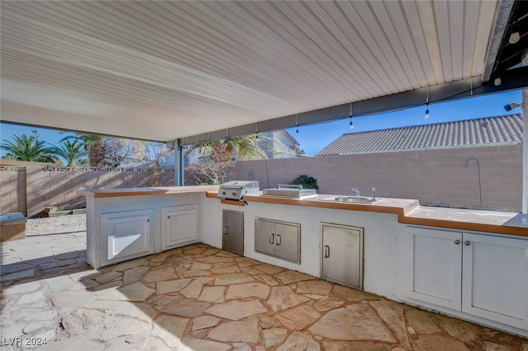 3153 Viewcrest Avenue Henderson, NV 89014 - Photo 44 of 49 Backyard features a large covered patio with flagstone flooring, built-in BBQ and a blank canvas backyard awaiting your creativity!