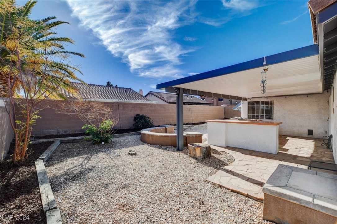 3153 Viewcrest Avenue Henderson, NV 89014 - Photo 45 of 49 Backyard features a large covered patio with flagstone flooring, built-in BBQ and a blank canvas backyard awaiting your creativity!