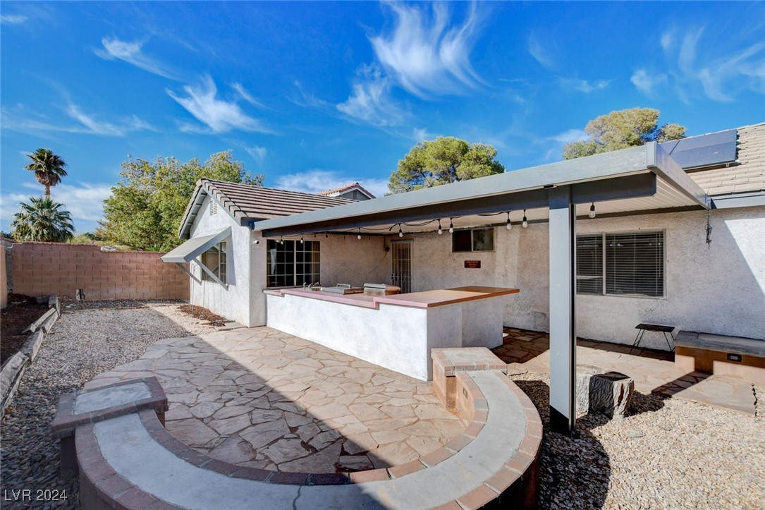3153 Viewcrest Avenue Henderson, NV 89014 - Photo 47 of 49 Backyard features a large covered patio with flagstone flooring, built-in BBQ and a blank canvas backyard awaiting your creativity!
