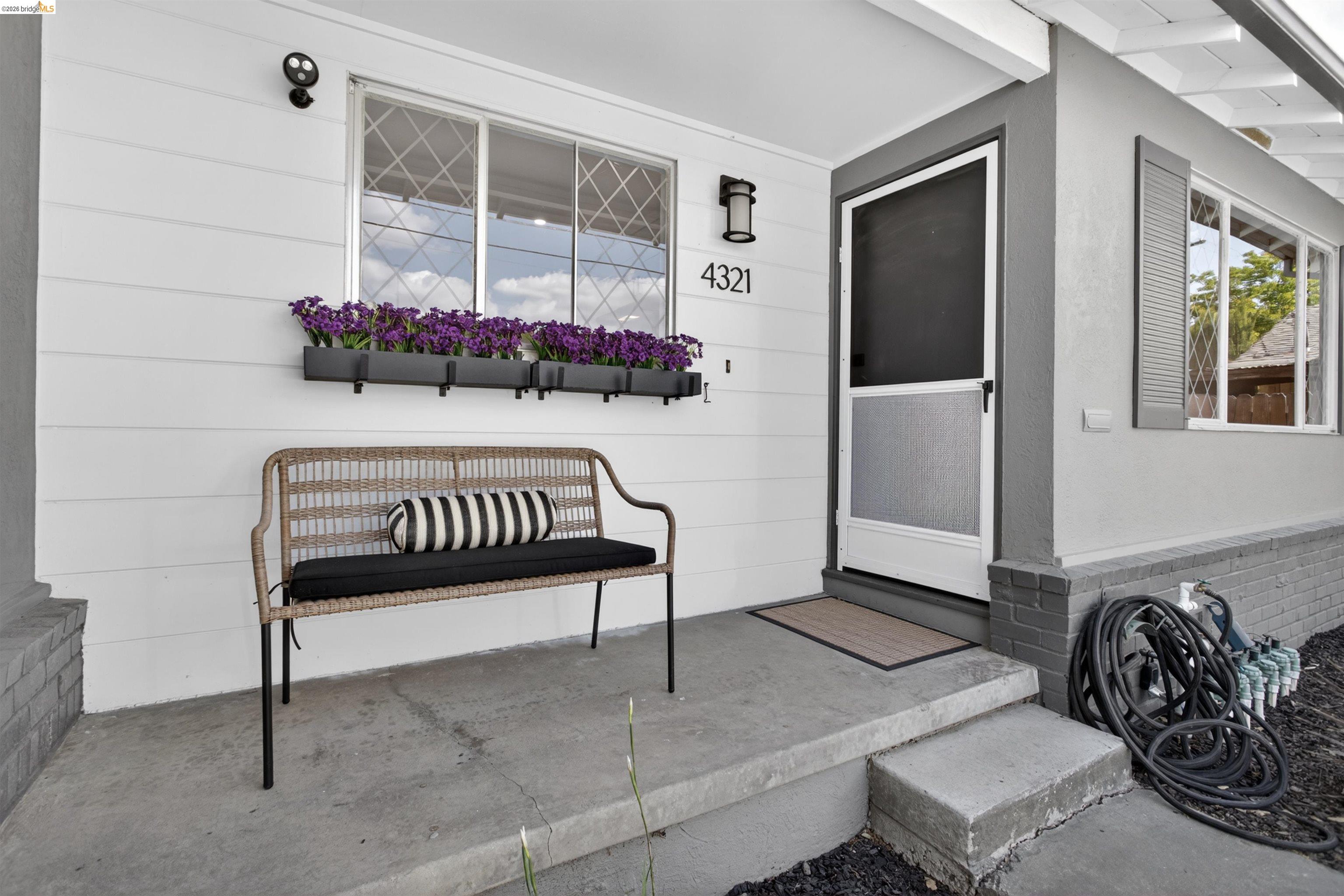 4321 Davis Way Livermore, CA 94550 - Photo 2 of 34 Inviting front porch featuring a white exterior with grey trim, a screen door, and visible house numbers