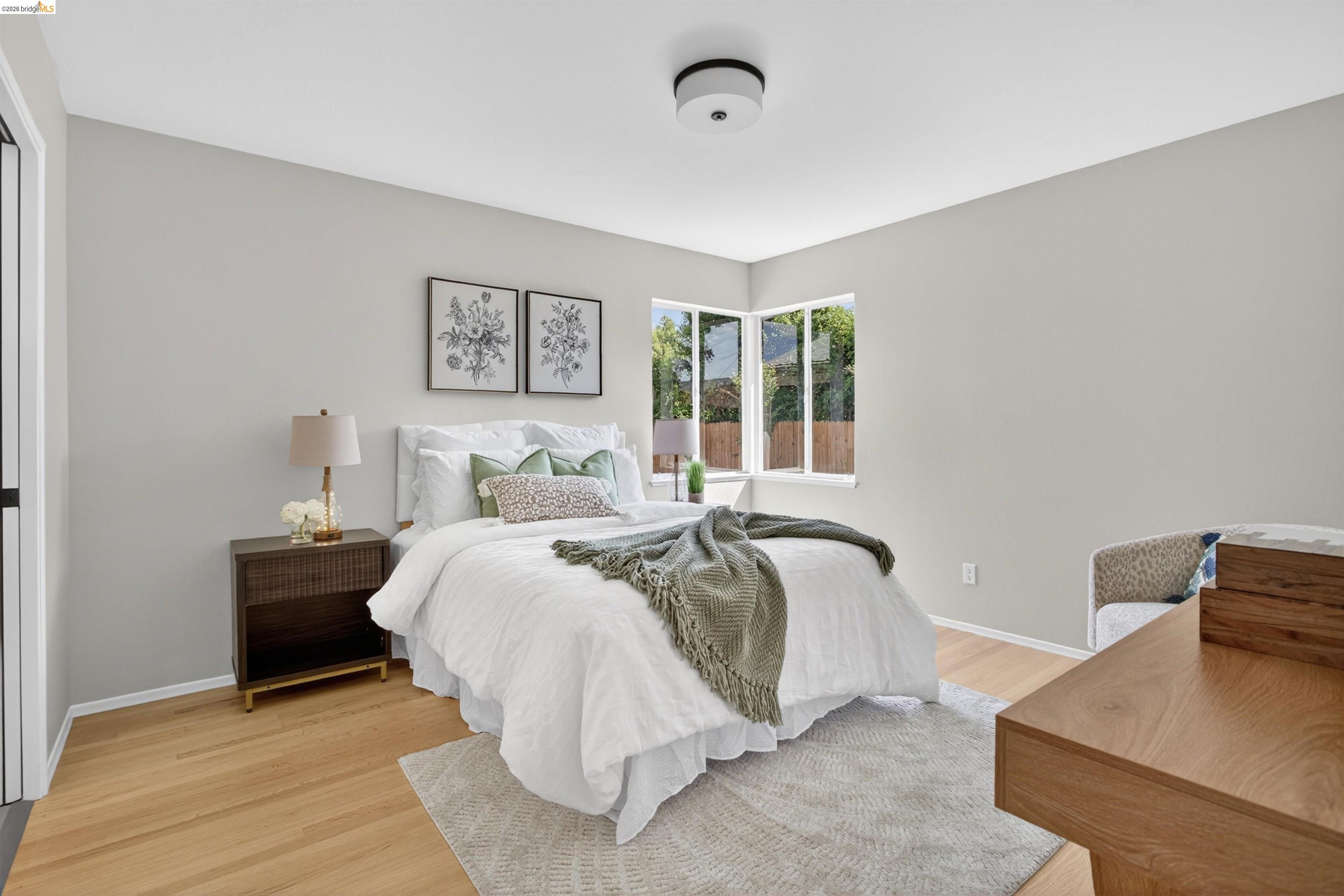 4321 Davis Way Livermore, CA 94550 - Photo 21 of 34 Bright bedroom featuring light wood-finish flooring and a corner window arrangement
