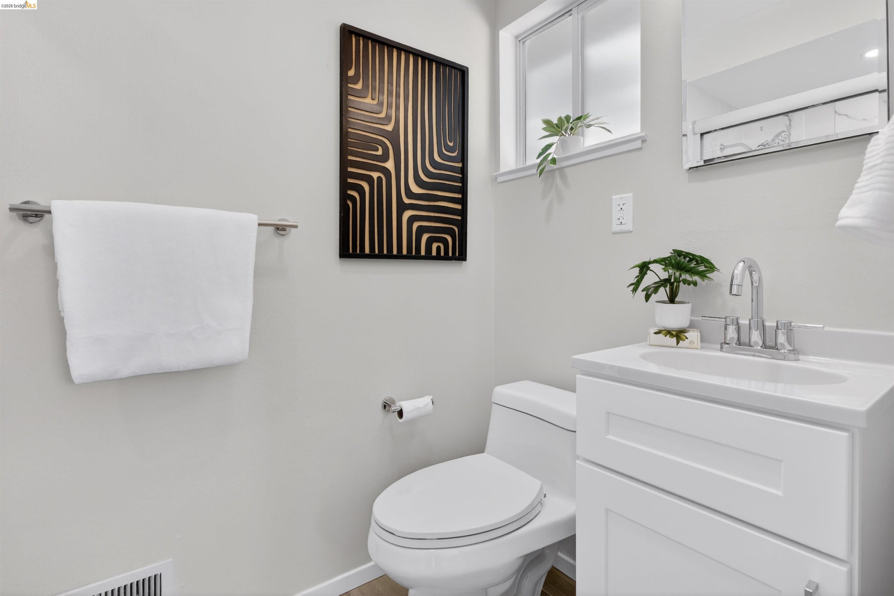 4321 Davis Way Livermore, CA 94550 - Photo 24 of 34 Bright bathroom featuring a white vanity with integrated sink, chrome faucet, and mirrored medicine cabinet