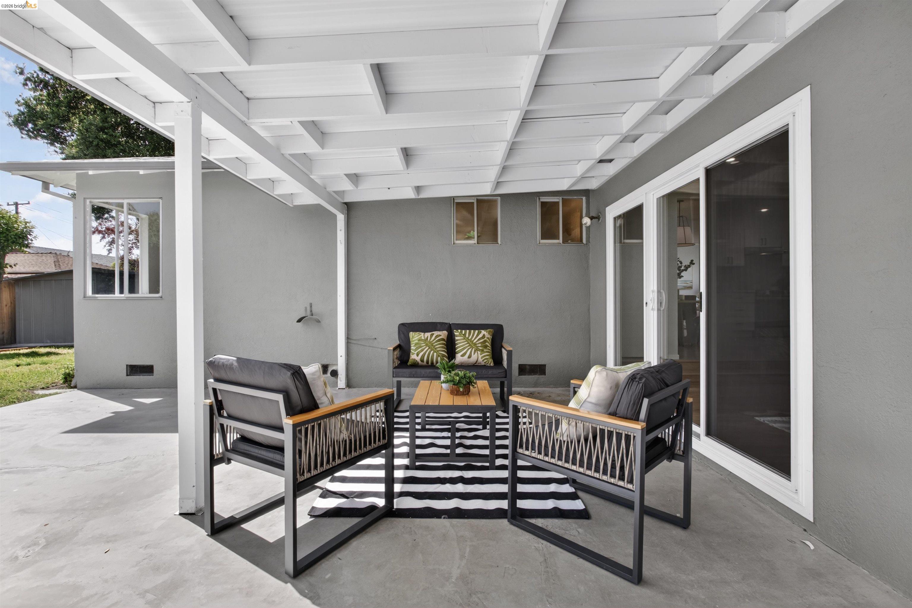 4321 Davis Way Livermore, CA 94550 - Photo 28 of 34 Spacious patio featuring a white pergola, concrete flooring, and direct access through large sliding glass doors