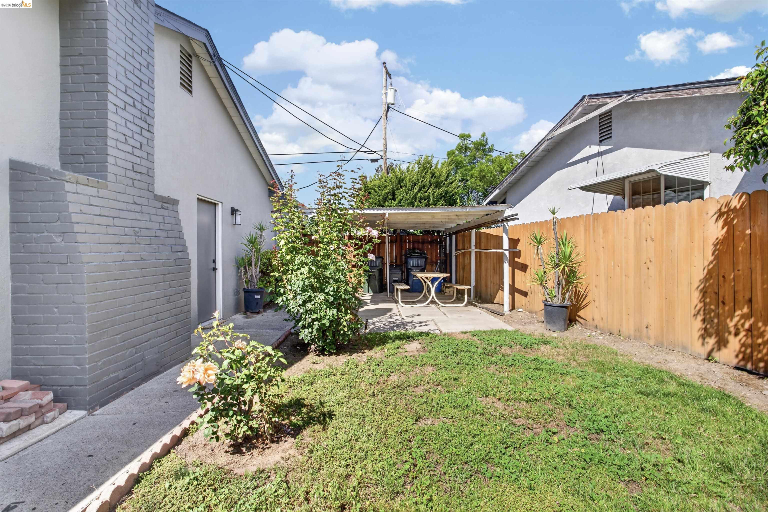 4321 Davis Way Livermore, CA 94550 - Photo 29 of 34 Private backyard featuring a covered patio area, concrete pathways, and a new wood fence