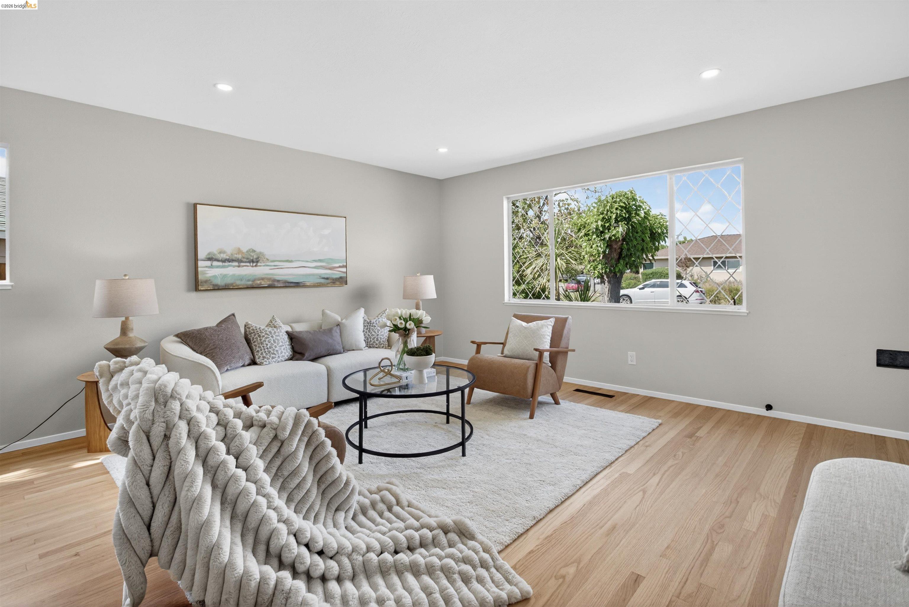 4321 Davis Way Livermore, CA 94550 - Photo 4 of 34 Living area featuring light wood-finish flooring, recessed lighting, and a large window with diamond-pattern grilles