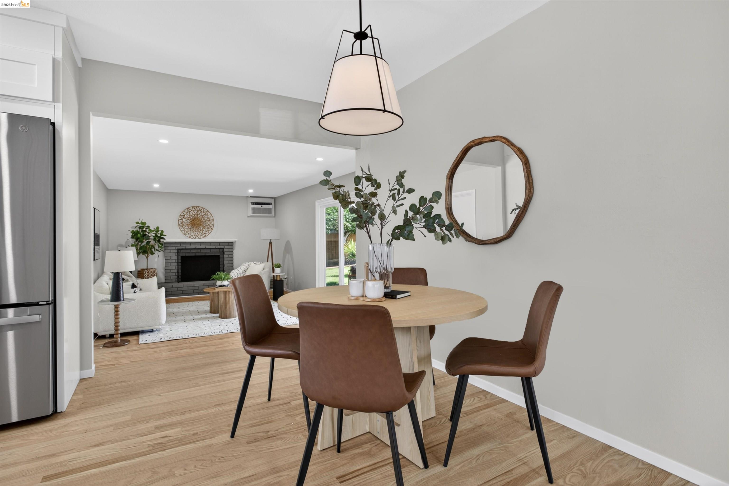 4321 Davis Way Livermore, CA 94550 - Photo 9 of 34 Dining area featuring wood-finish flooring, a contemporary pendant light fixture, and a neutral color palette