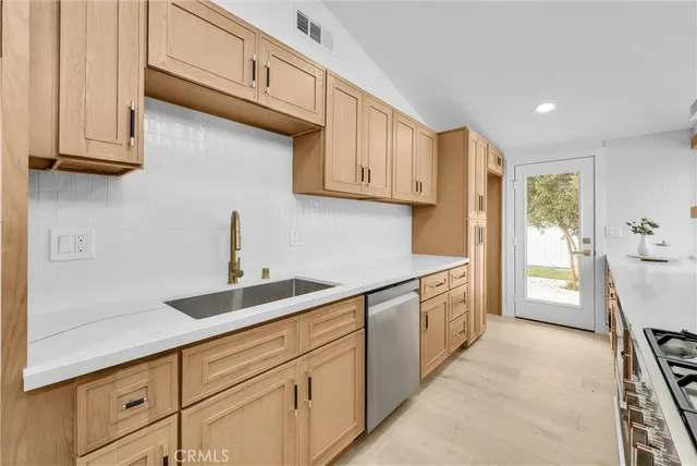 a kitchen with a sink and cabinets