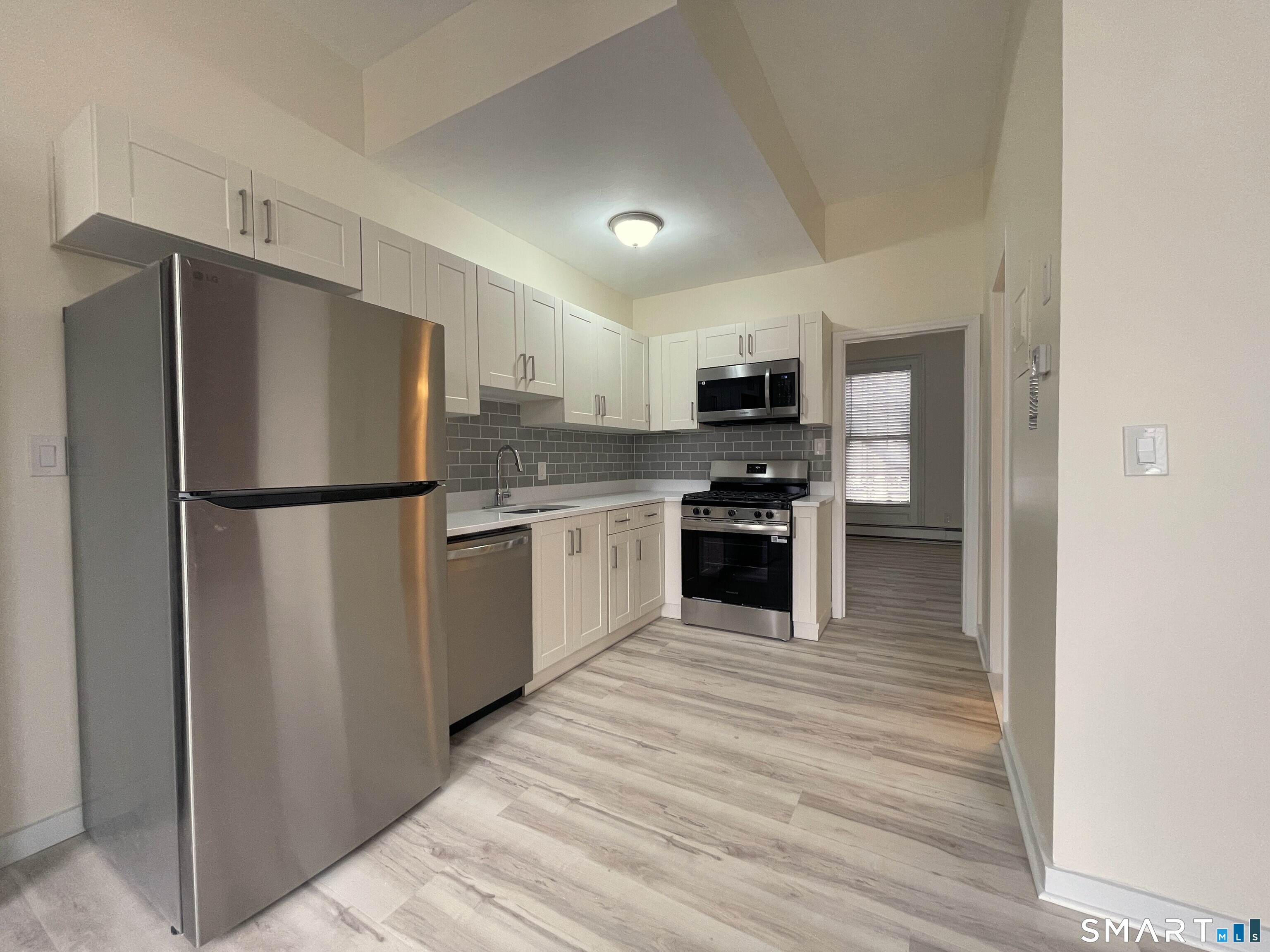 a kitchen with stainless steel appliances granite countertop a refrigerator stove a sink and dishwasher