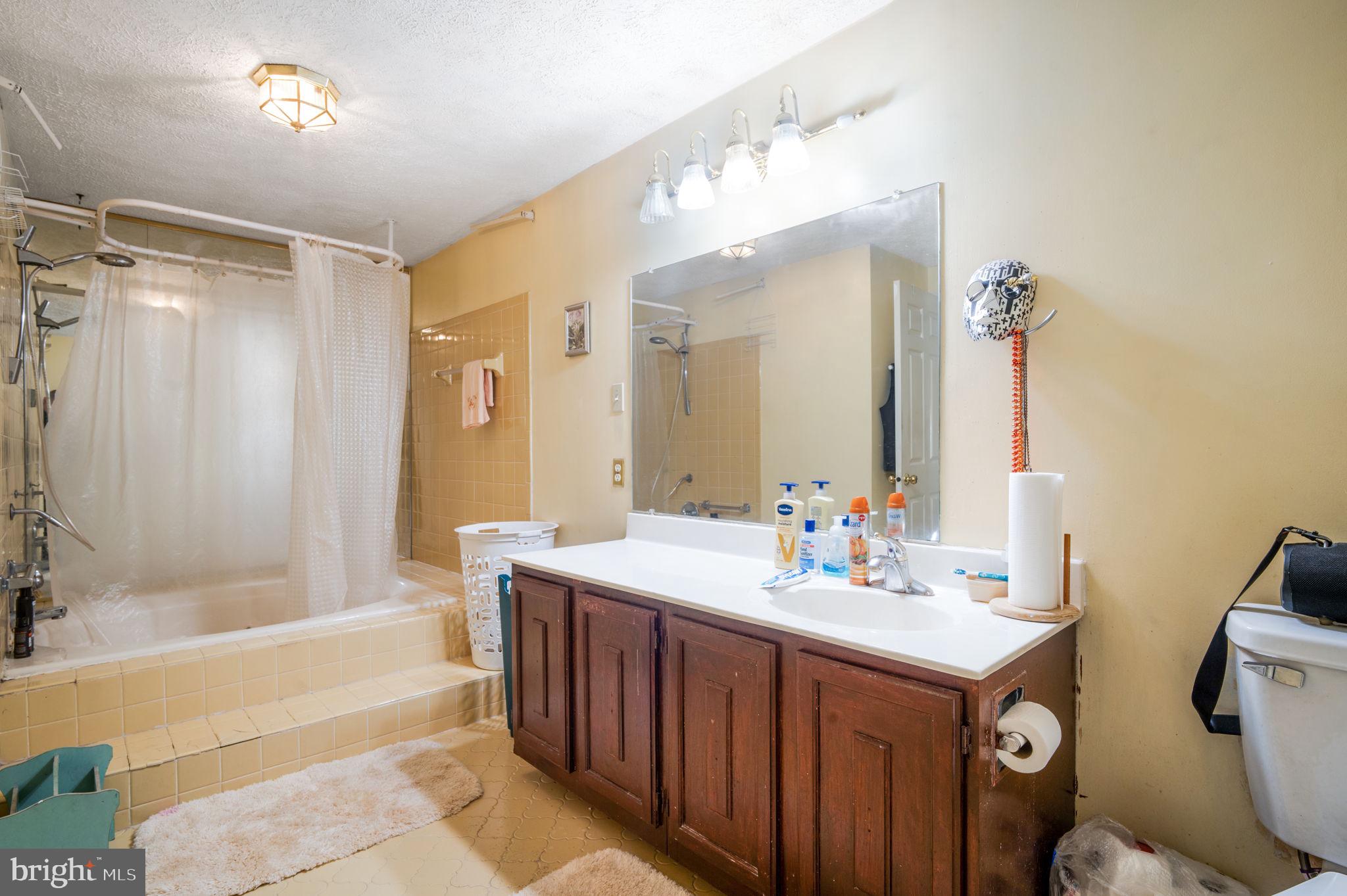 11006 Lake Arbor Way Bowie, MD 20721 - Photo 26 of 46 a bathroom with a sink double vanity mirror and a bathtub