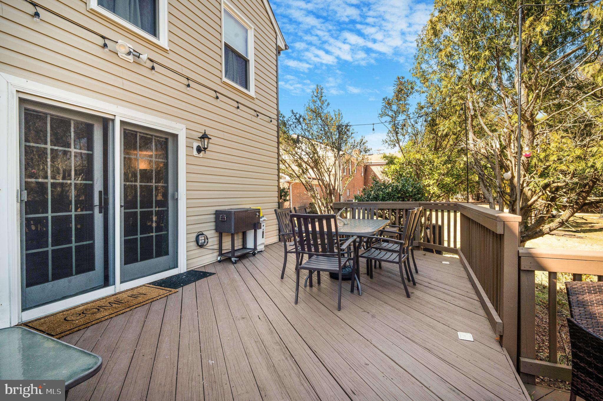 11006 Lake Arbor Way Bowie, MD 20721 - Photo 38 of 46 a view of a roof deck with table and chairs floor to ceiling window with wooden floor