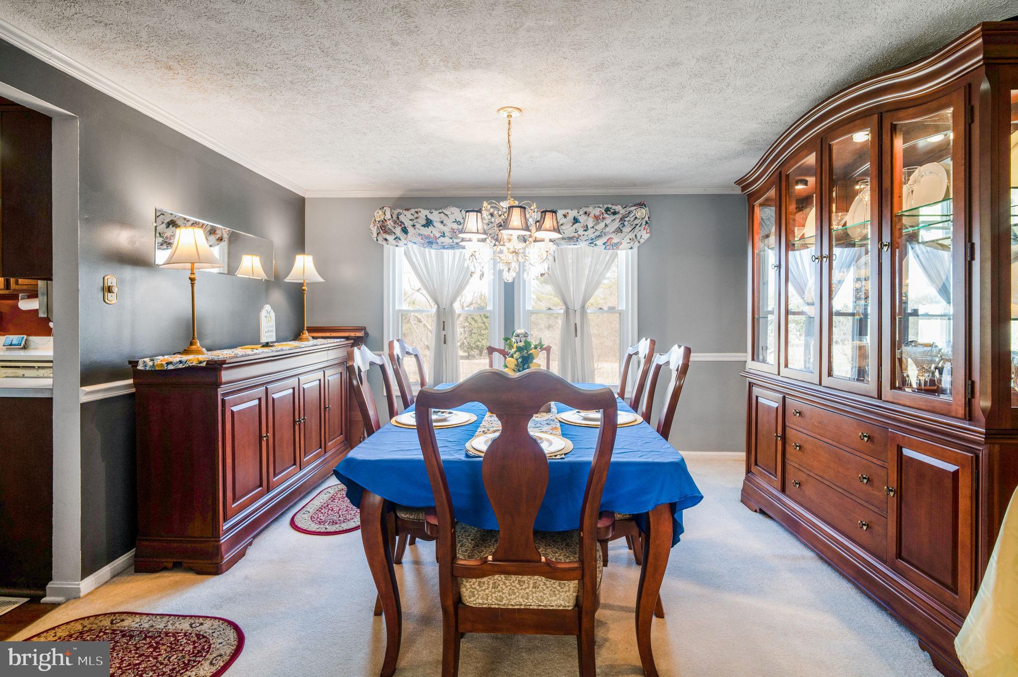 11006 Lake Arbor Way Bowie, MD 20721 - Photo 8 of 46 a view of a dining room with furniture a chandelier and wooden floor
