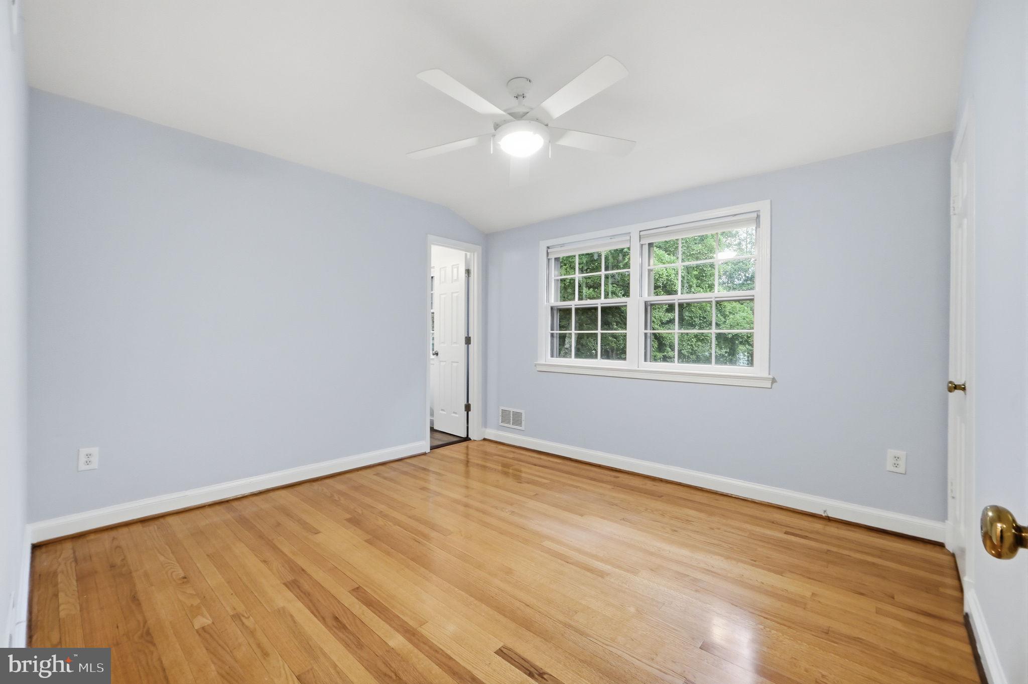 5910 Overlea Road Bethesda, MD 20816 - Photo 35 of 56 an empty room with wooden floor and windows