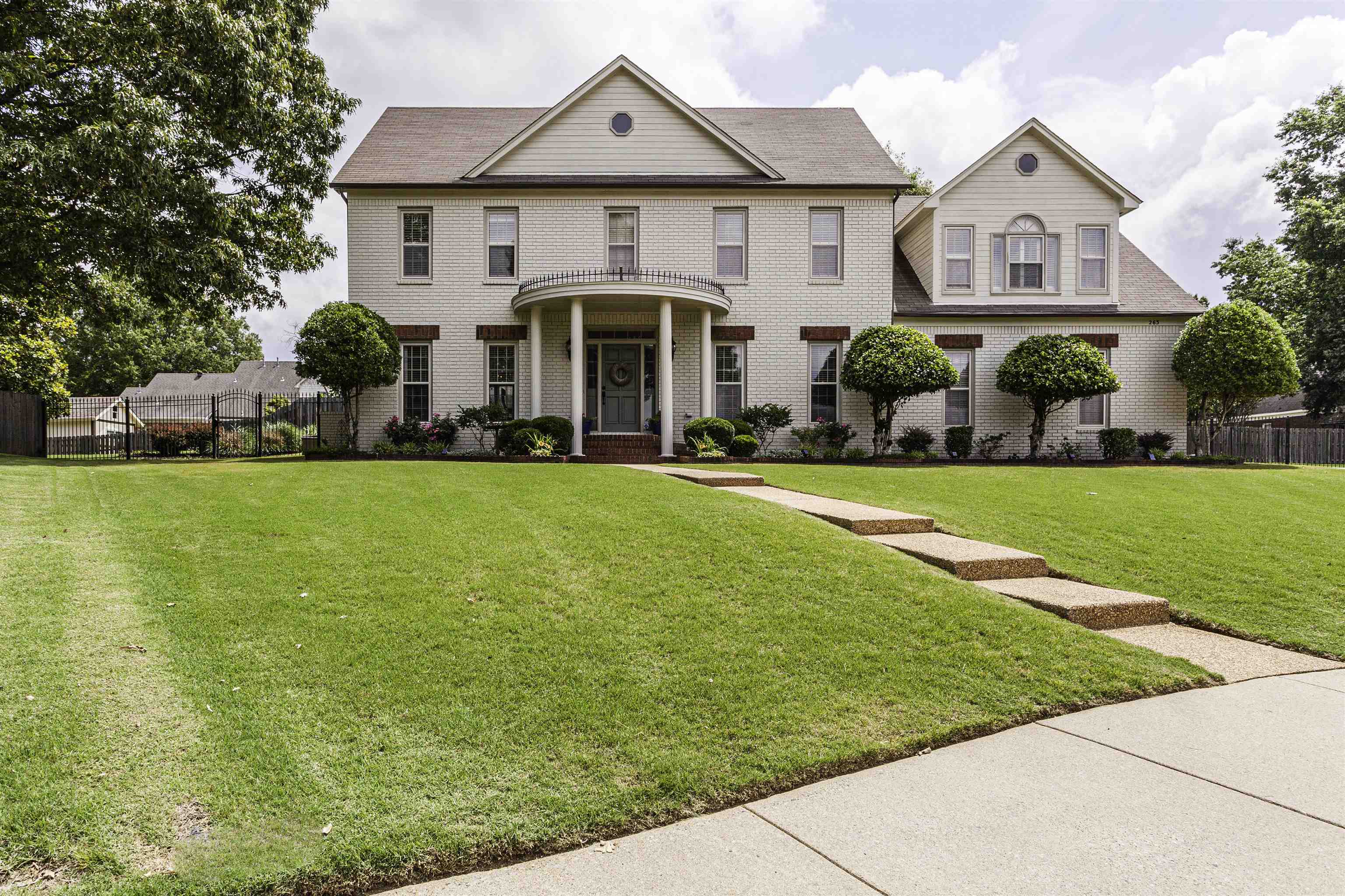 263 Hound Ridge Cove Collierville, TN 38017 - Photo 1 of 25 a view of a white house with a big yard and large trees