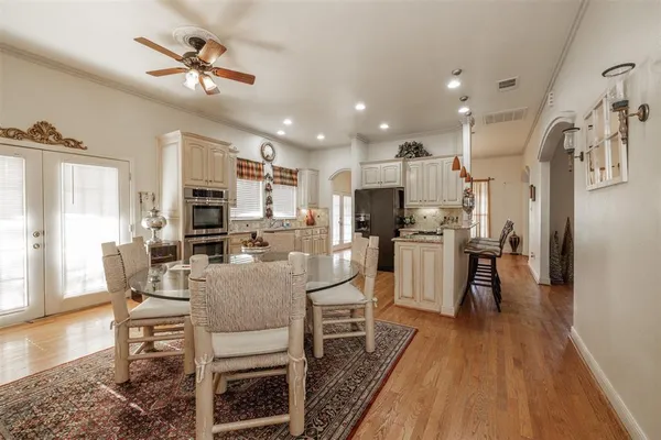 a kitchen with kitchen island granite countertop stainless steel appliances and wooden cabinets