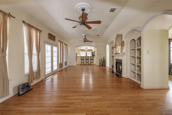 wooden floor in an empty room with a window
