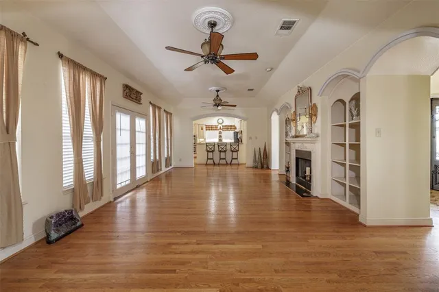 wooden floor in an empty room with a window