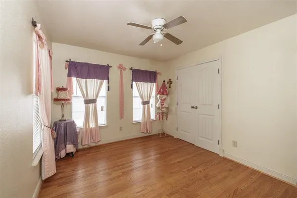 a bedroom with furniture window and wooden floor