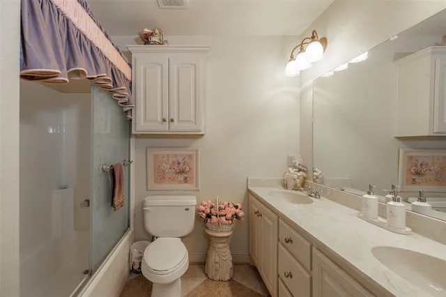 a bathroom with a granite countertop sink mirror and bathtub