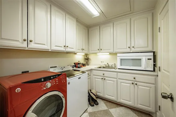 a spacious bathroom with a double vanity sink a mirror and a shower